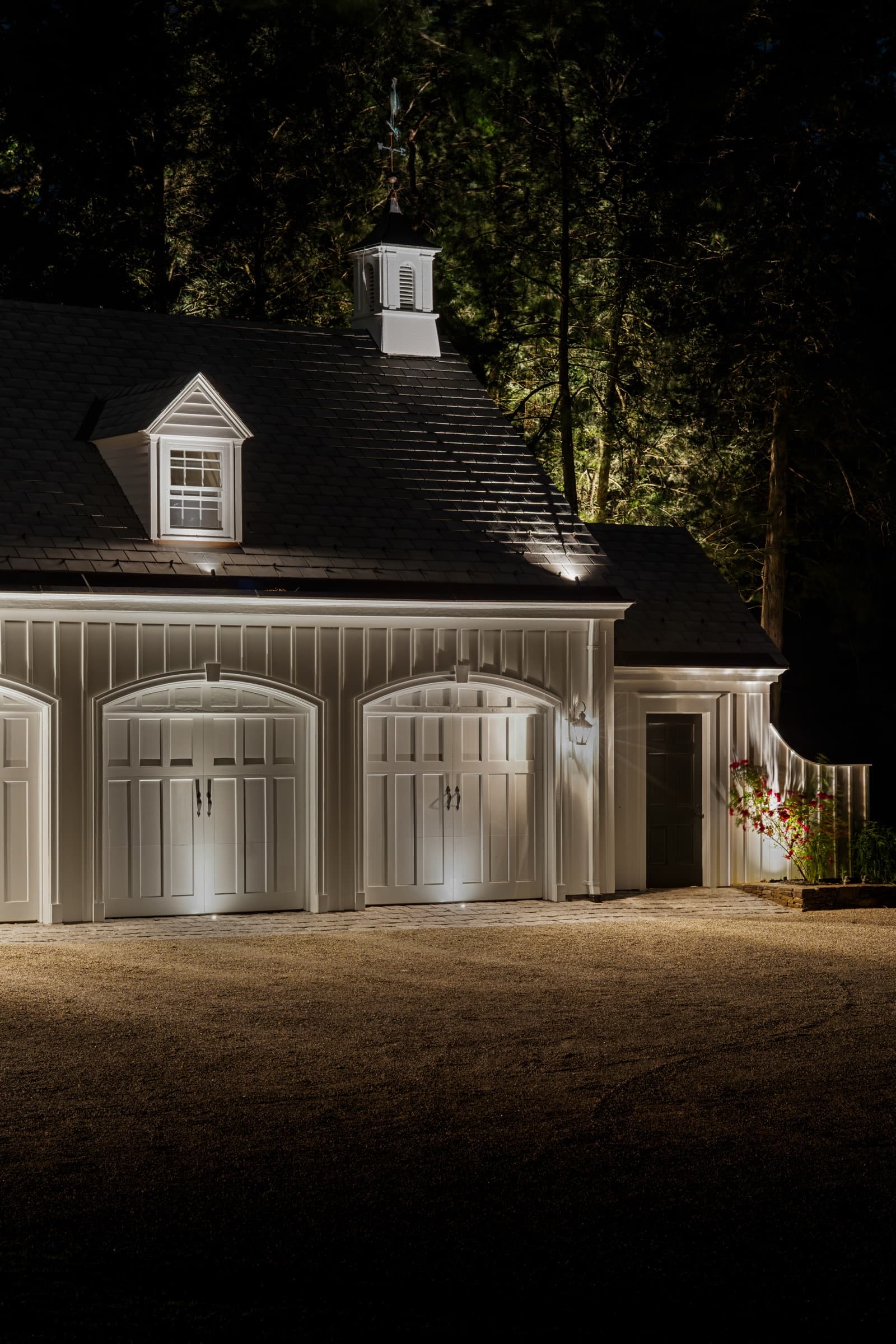 Carriage house and garage bays lit from below